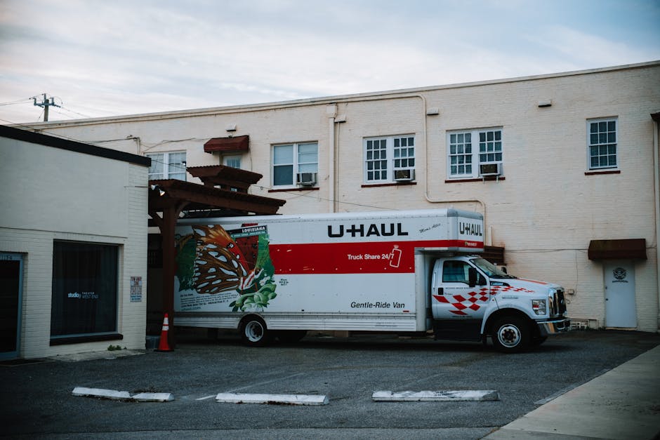 Large moving truck parked outside a beautiful residential house